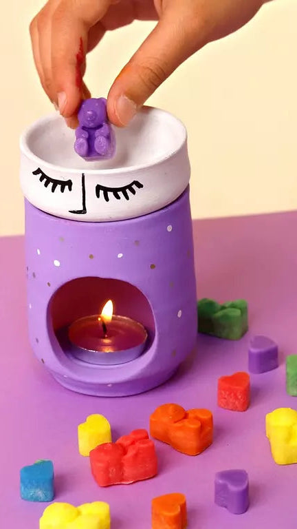 Purple toy incense burner with colorful blocks and a hand placing a block inside, on a purple background with 'Funlab' branding.